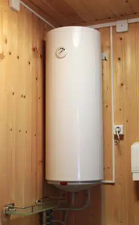 electric water heater hanging on the wooden wall